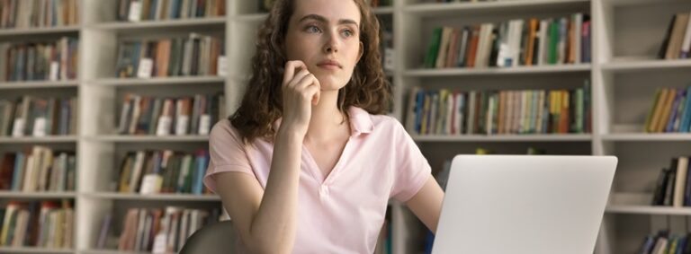 thoughtful girl choosing a movie on her laptop